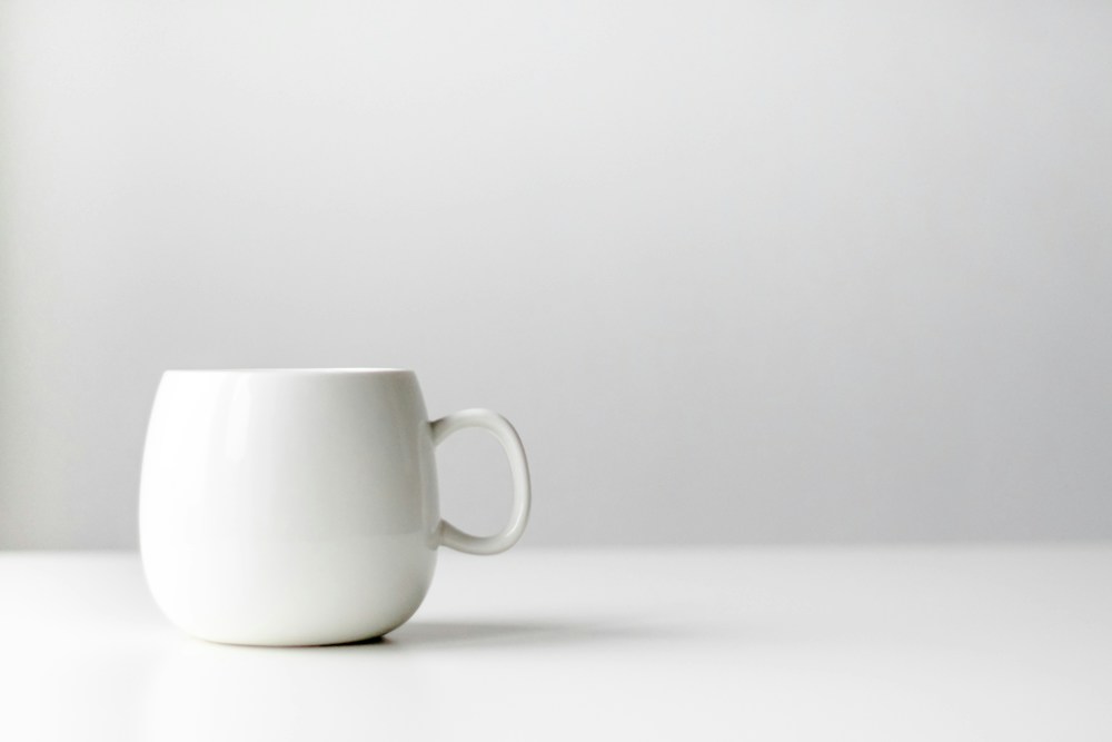 White ceramic mug, fully visible against a plain background